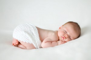 sleeping newborn baby on a blanket