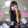 woman covering face with playing card