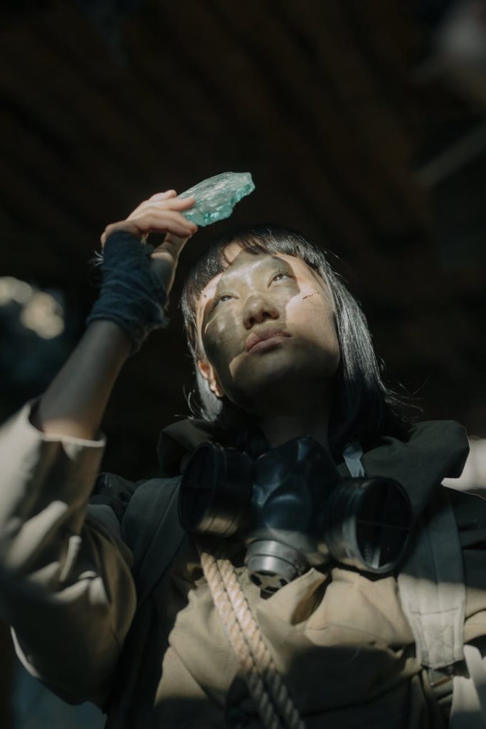 woman in black leather jacket holding green plastic pack