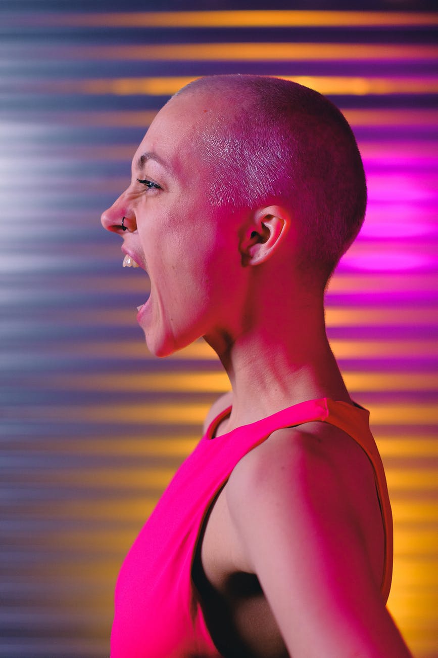 expressive bald woman shouting in studio
