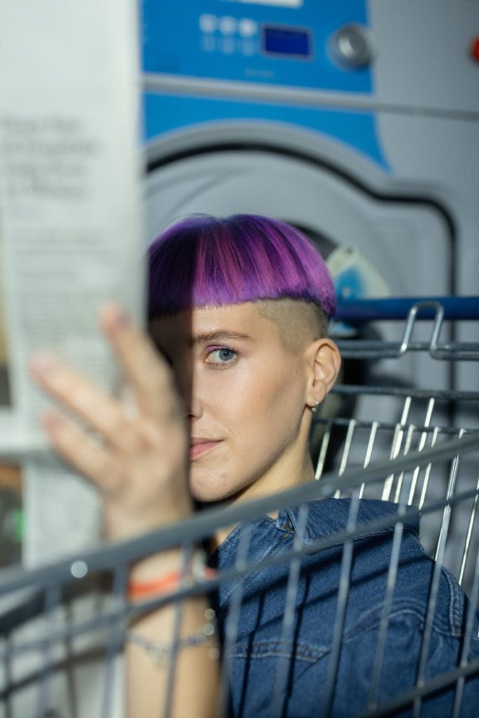 a woman in blue denim jacket holding a newspaper