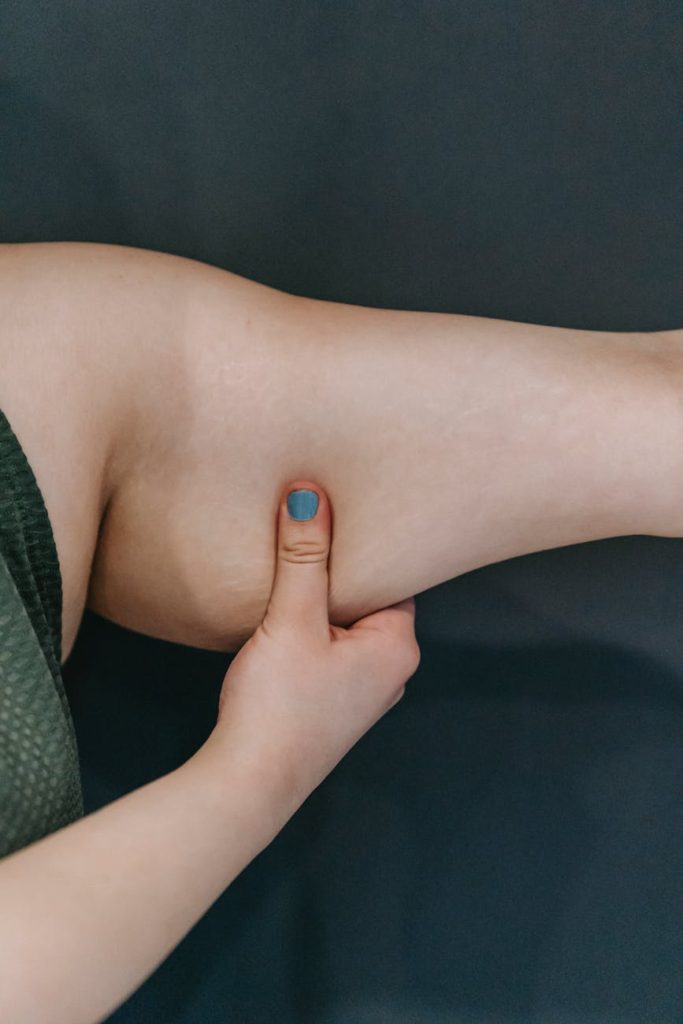 anonymous overweight woman touching triceps before training