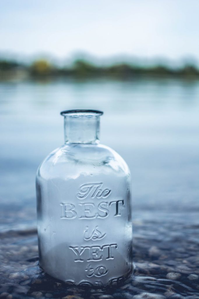 clear glass jar in body of water