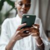 black woman messaging on modern cellphone