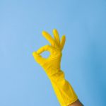 crop faceless person in rubber glove showing okay gesture