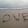 brown sand love text on seashore
