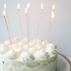 photo of white cake with candles on top