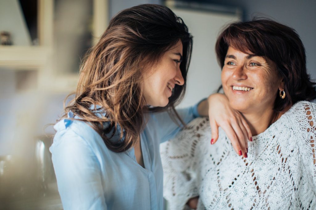 two women smiling at each other