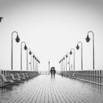two people walking on pier