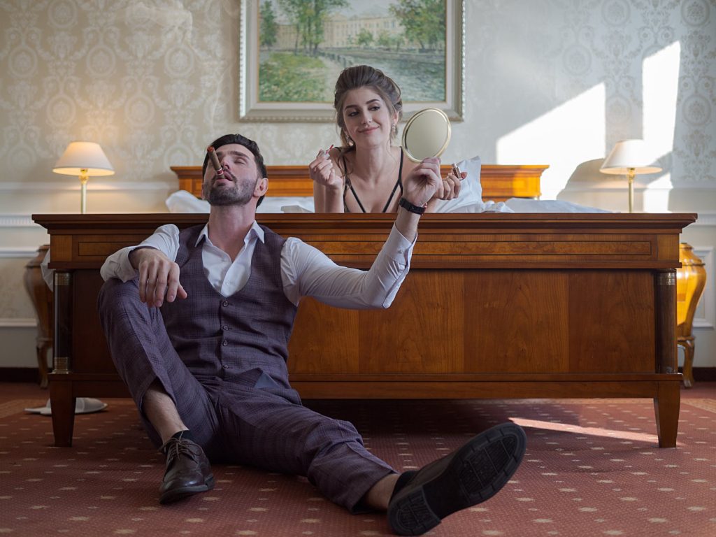 couple relaxing in bed in hotel