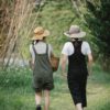 faceless gardeners strolling on path near grass in nature