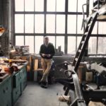 photo of man standing inside his workshop