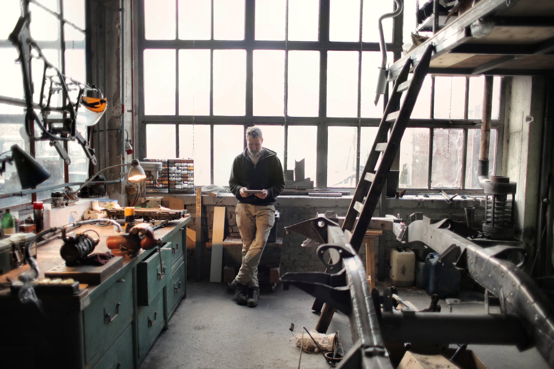 photo of man standing inside his workshop