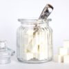 close up photo of sugar cubes in glass jar