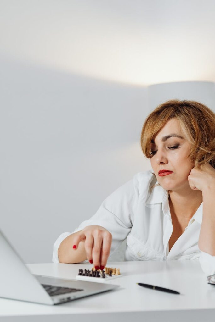 a bored woman playing chess
