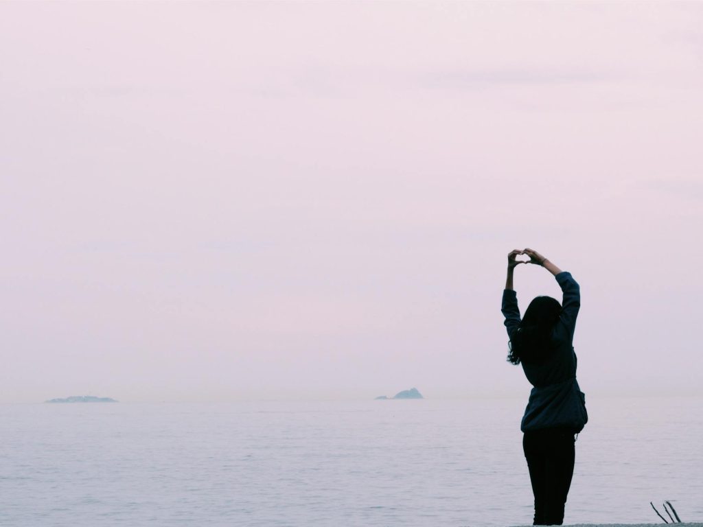 woman standing near body of water
