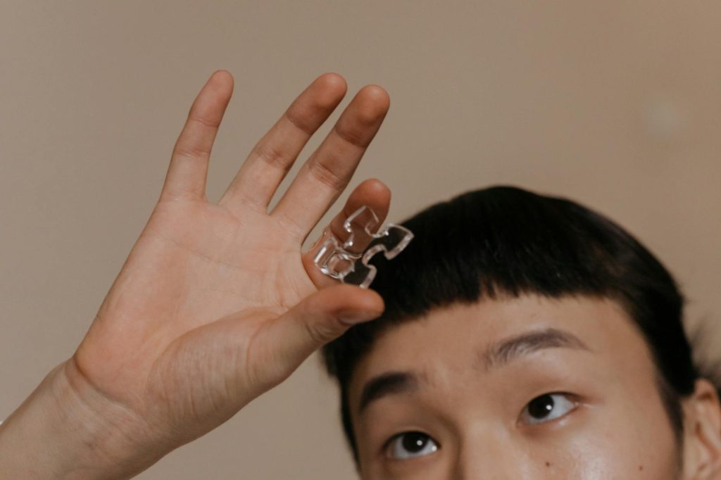a person holding a piece of glass puzzle